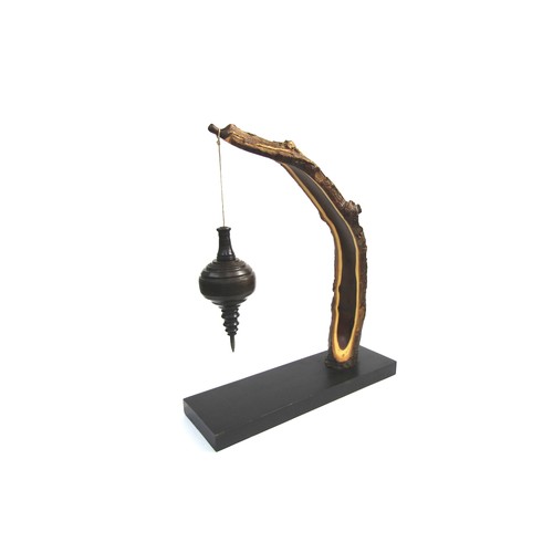 7544 - RICHARD CHAPMAN (b.1951) An Ebony and Laburnum sculpture, the Laburnum arching arm holding a turned ... 