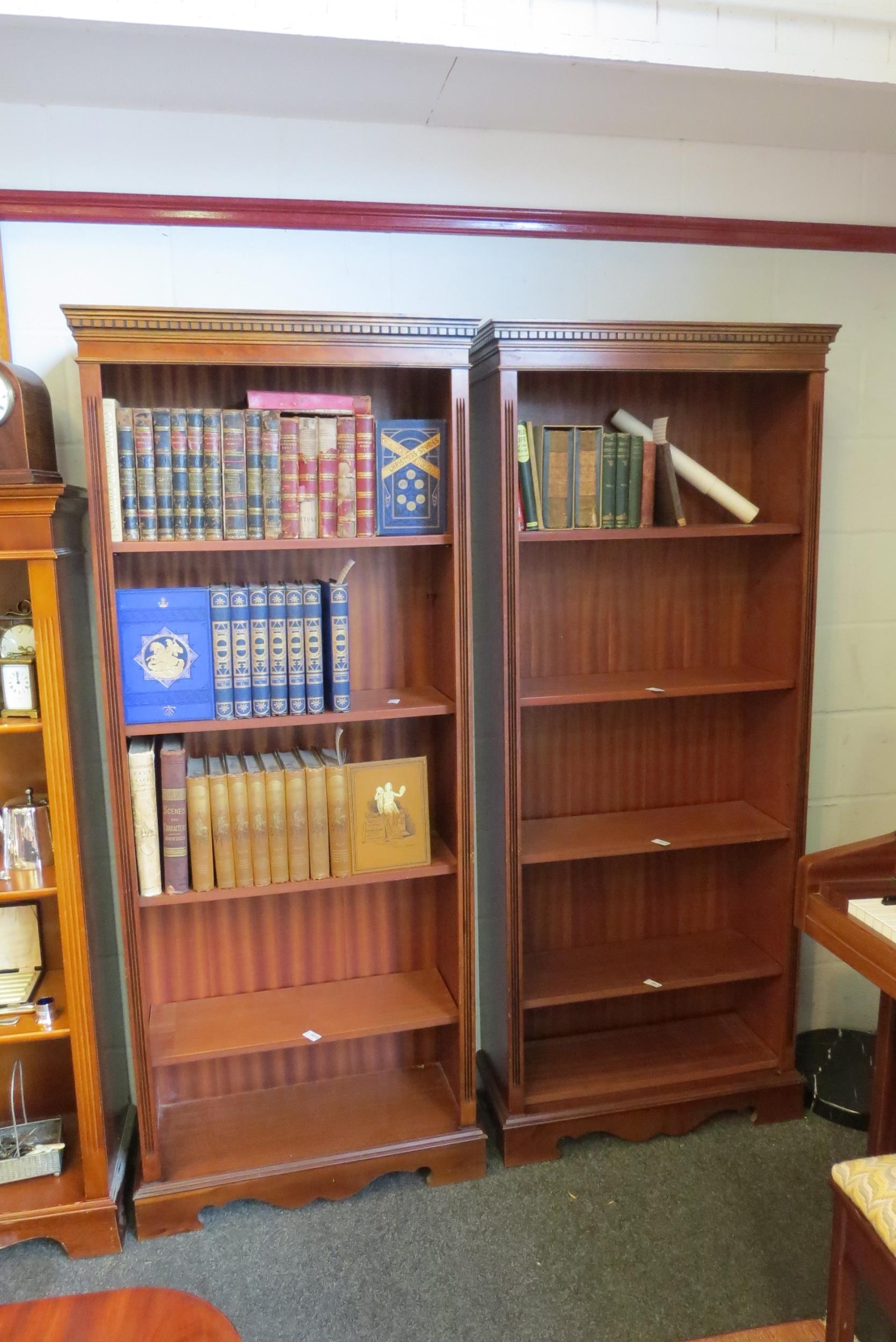 A pair of reproduction mahogany full height bookcases, dentil moulded ...