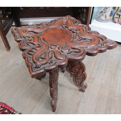 5020 - A 19th Century Chinese carved hardwood folding writing table and stool, allover carved decoration of... 