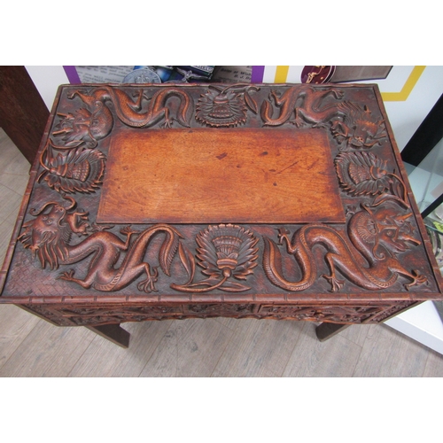 5020 - A 19th Century Chinese carved hardwood folding writing table and stool, allover carved decoration of... 