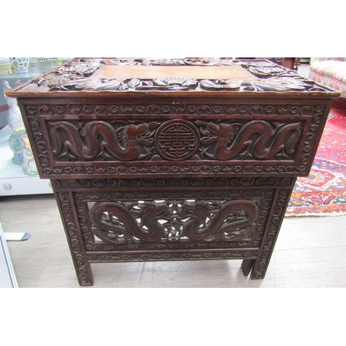 5020 - A 19th Century Chinese carved hardwood folding writing table and stool, allover carved decoration of... 