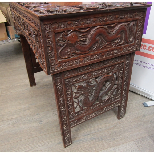 5020 - A 19th Century Chinese carved hardwood folding writing table and stool, allover carved decoration of... 