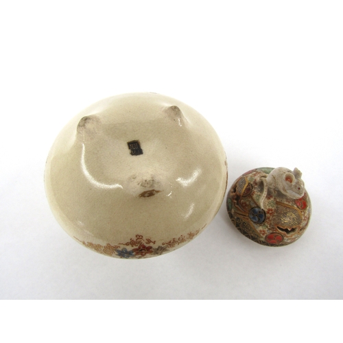 5029 - A Japanese satsuma lidded pot. The lid surmounted by a rat, the base decorated with landscape and fi... 