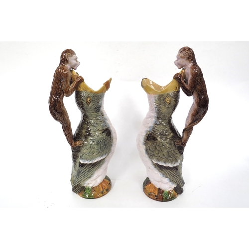 5034 - A pair of William Brownfield majolica jugs in the form of birds with open beaks and monkeys atop as ... 