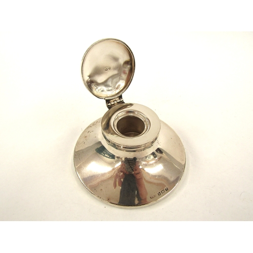 5063 - A silver Capstan inkwell, Birmingham 1920, wooden weighted base, 10.5cm diameter, makers mark rubbed... 