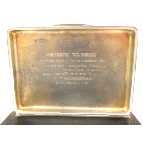 5065 - A solid silver Sampson Morden & Co cigarette box, London 1911, with inscription to the interior of t... 