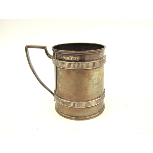 5069 - A George III silver tankard of plain barrel form, London 1808, makers mark unclear, 7.6cm tall, 162g