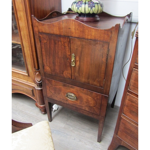 5453 - A George III mahogany nightstand the fret handled raised wavy Gallery over a two door cupboard and s... 