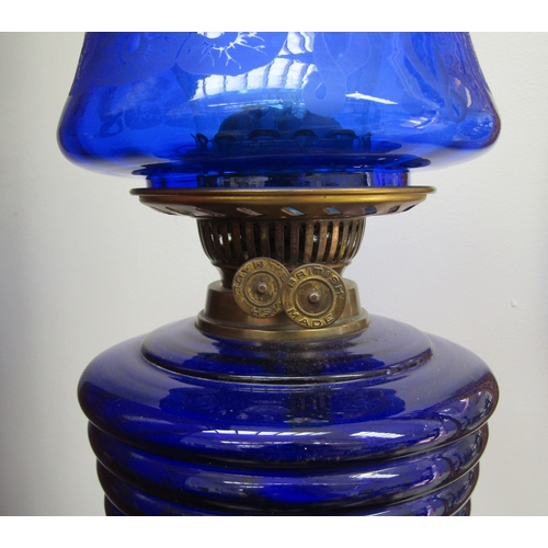 5471 - An early 20th Century English made column form oil lamp with blu art nouveau shade and ribbed blue g... 