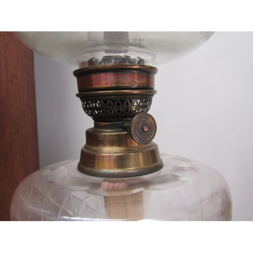 5475 - A French clear glass and brass column form oil lamp. The shade with etched leaf design the reservoir... 