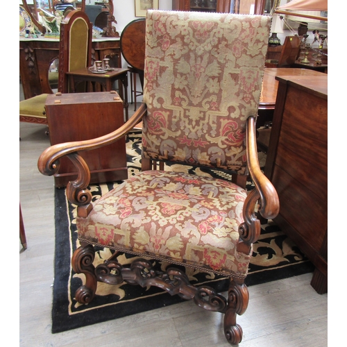 5487 - A walnut Carolean revival tapestry upholstered armchair the outswept scroll arms on scroll forelegs ... 