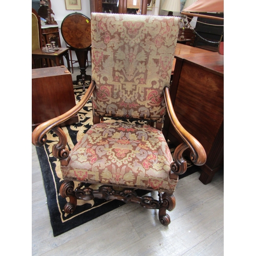 5487 - A walnut Carolean revival tapestry upholstered armchair the outswept scroll arms on scroll forelegs ... 