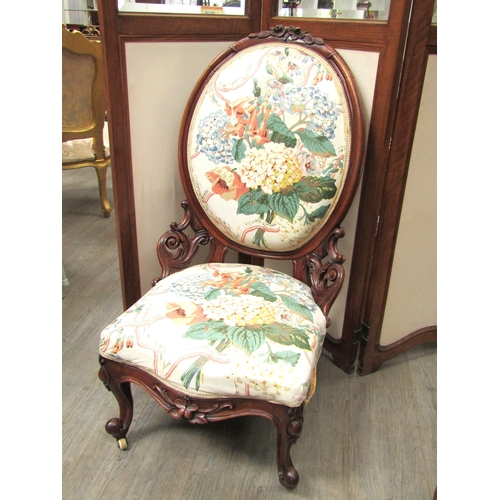 5489 - A Victorian oval back ladies open armchair with floral upholstery. Edging needs regluing. 102cm tall... 