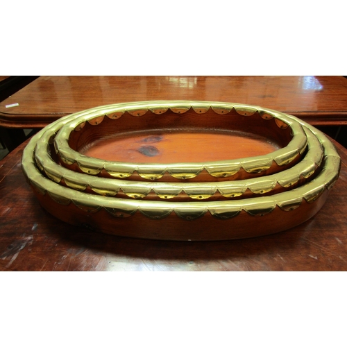 5492 - A set of Indian influenced pine oval stacking trays. Longest 57cm