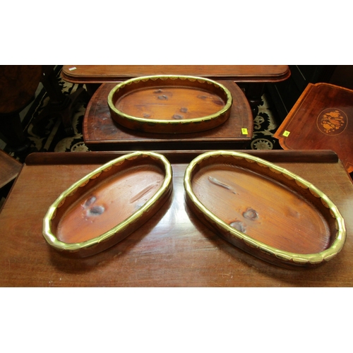 5492 - A set of Indian influenced pine oval stacking trays. Longest 57cm