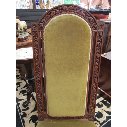 5494 - A late Victorian oak high back chair with highly ornate carving, velour upholstered back and seat  (... 