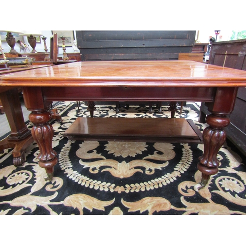 5499 - An early Victorian mahogany extending dining table, round-cornered top, on fluted supports to castor... 