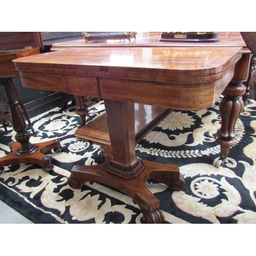 5504 - Circa 1830.  A William IV crossbanded flame mahogany card table the fold over hinged baize top on a ... 