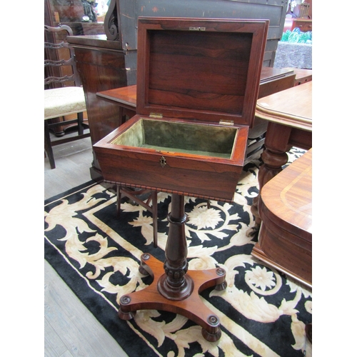 5505 - A circa 1830 Regency rosewood sarcophagus shape work table with velvet lined interior over a turned ... 