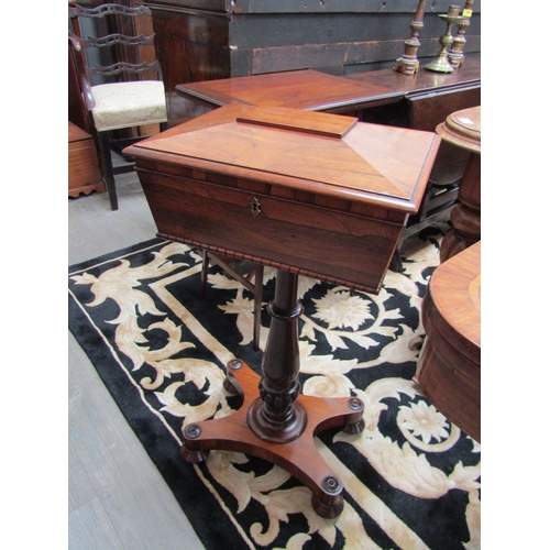 5505 - A circa 1830 Regency rosewood sarcophagus shape work table with velvet lined interior over a turned ... 