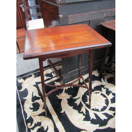 5507 - An Edwardian crossbanded mahogany games table, the fold over baize swivel top on a shape frieze and ... 