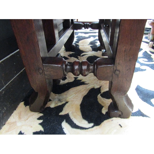 5508 - An 18th Century (Queen Anne Period) pegged oak oval top gate-leg table, the rising leaves over a sin... 