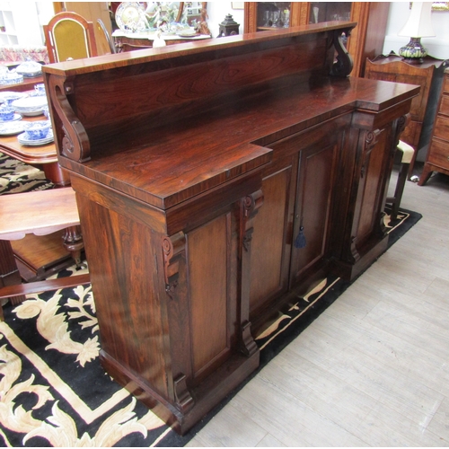 5511 - Circa 1830 a William IV rosewood breakfront chiffonier, the raised shelf back with caved 