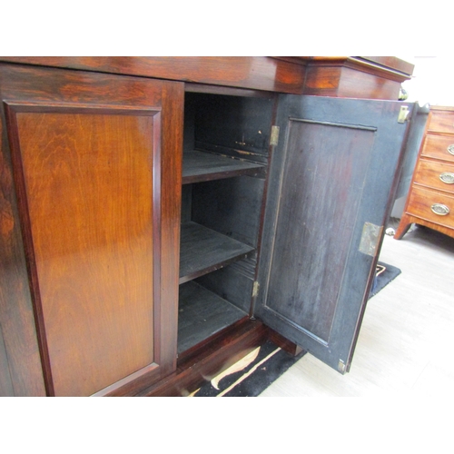 5511 - Circa 1830 a William IV rosewood breakfront chiffonier, the raised shelf back with caved 