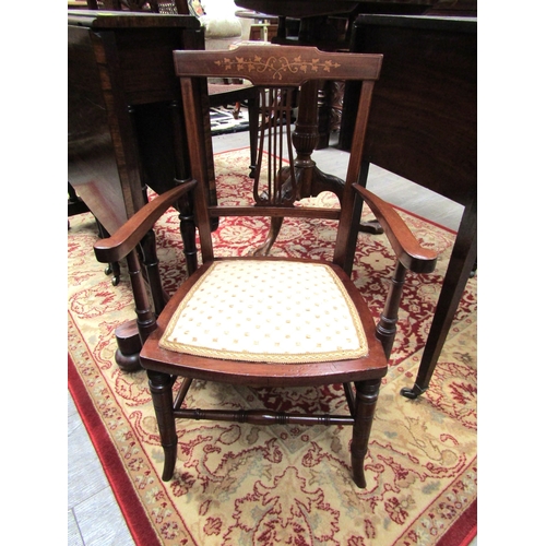 5514 - An Edwardian inlaid mahogany child's armchair, the pierced fretwork central splat and scroll arms on... 