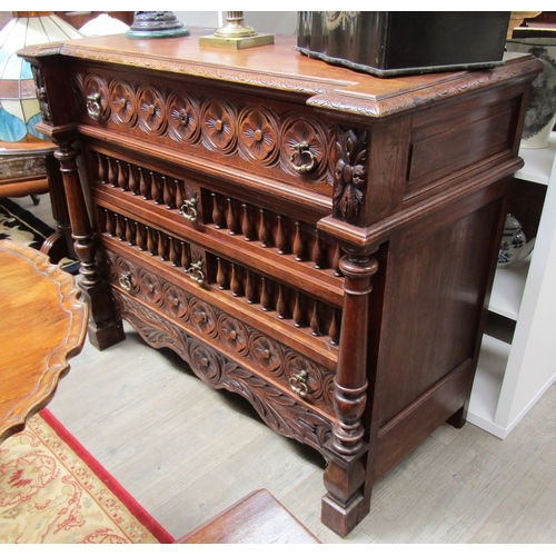 5519 - A 19th Century oak breakfront chest of four drawers having carved and turned decoration with turned ... 