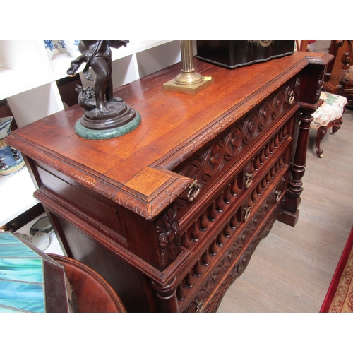 5519 - A 19th Century oak breakfront chest of four drawers having carved and turned decoration with turned ... 