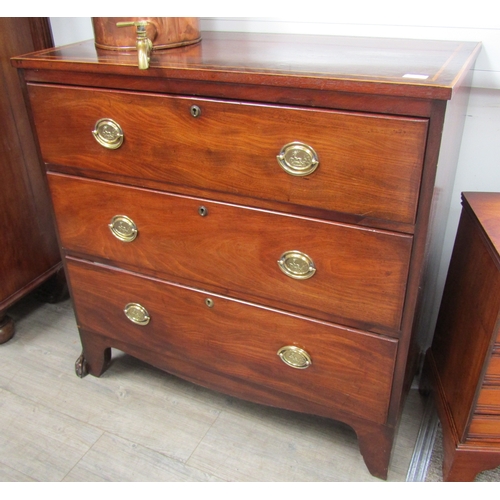 5680 - A 19th Century chest of three long drawers, satinwood inlaid top, oval brass handles, on bracket sup... 