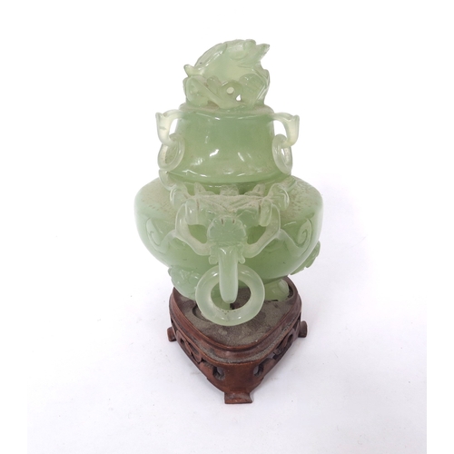 5050 - An oriental carved jade lidded Koro dragon masks and ring handles on tripod feet with fitted carved ... 