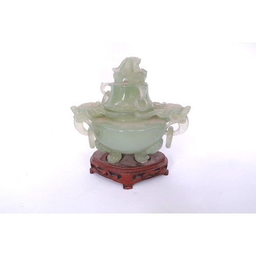 5050 - An oriental carved jade lidded Koro dragon masks and ring handles on tripod feet with fitted carved ... 