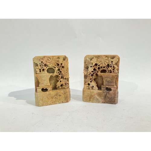 5027 - A pair of deeply carved soapstone bookends depicting flowers in a vase. 13.5cm high