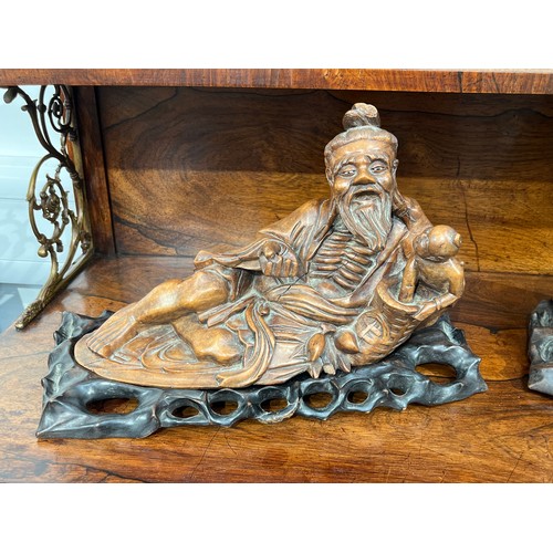 5052 - A pair of Oriental carved wooden deities on shaped plinths, approx 35.5cm long x 22cm high  (R)  £25... 