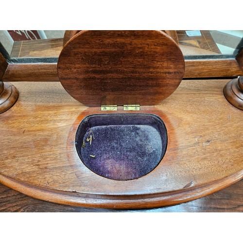 5693 - A Victorian mahogany dressing table mirror with barley twist supports, the bottom with a velvet line... 