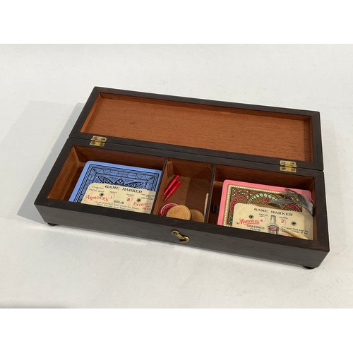 5057 - A Victorian bone inlaid card games box with playing cards and counters, the box contains whist marke... 