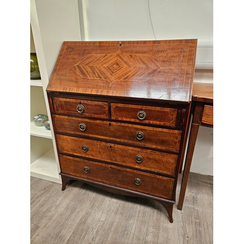 5689 - An Edwardian mahogany bureau with crossbanding and line inlaid decoration, the three drawer interior... 