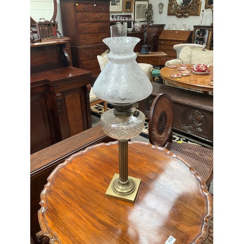 5517 - A late 19th Century/early 20th Century oil lamp with brass column base, cut glass reservoir. Highly ... 