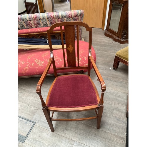 5493 - In the manner of 'Maple & Co', an Edwardian inlaid mahogany open armchair on turned and square taper... 