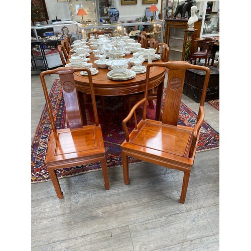 5696A - A teak Burmese oval extending dining table with 3 extra leaves and 10 chairs,  270cm long