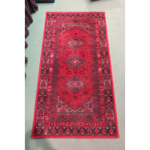 4003 - A Super Taj Belgian red ground wool rug with multiple borders, 156cm x 83cm