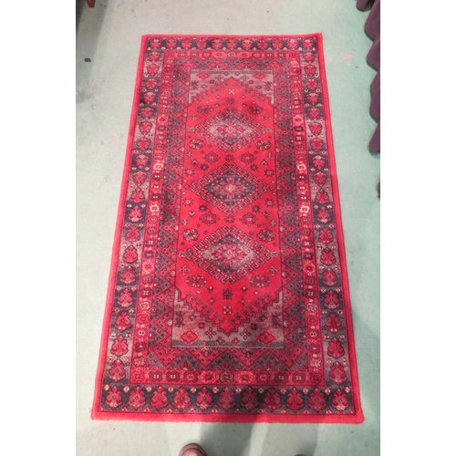 4003 - A Super Taj Belgian red ground wool rug with multiple borders, 156cm x 83cm