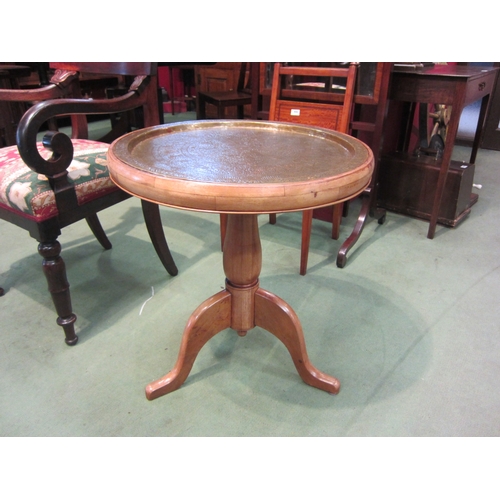 4010 - A French fruitwood circular top occasional table, the ornate brass recessed top over a turned column... 