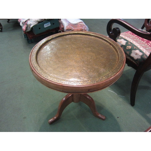 4010 - A French fruitwood circular top occasional table, the ornate brass recessed top over a turned column... 