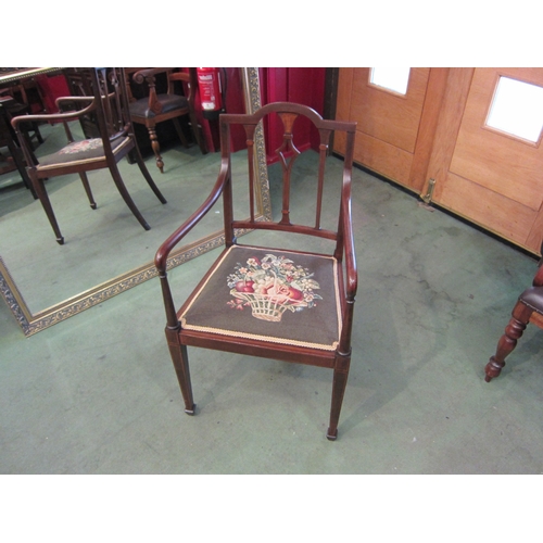 4020 - An Edwardian inlaid mahogany armchair with chequer strung decoration, the floral tapestry seat over ... 