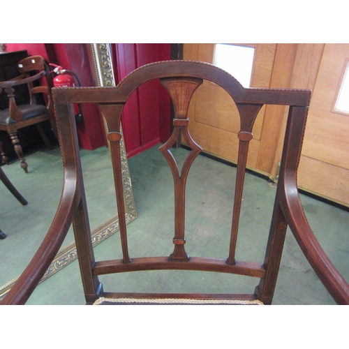 4020 - An Edwardian inlaid mahogany armchair with chequer strung decoration, the floral tapestry seat over ... 