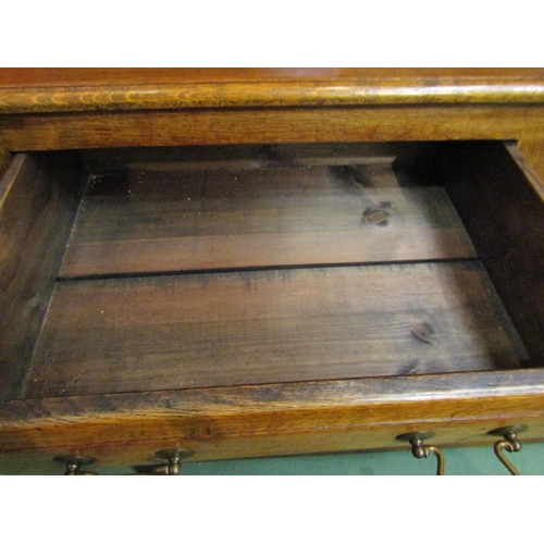 4042 - A George III style oak Welsh dresser with raised shelved back having two small cupboards over a thre... 