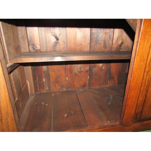 4042 - A George III style oak Welsh dresser with raised shelved back having two small cupboards over a thre... 